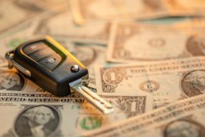 Car Key on top of dollar bills