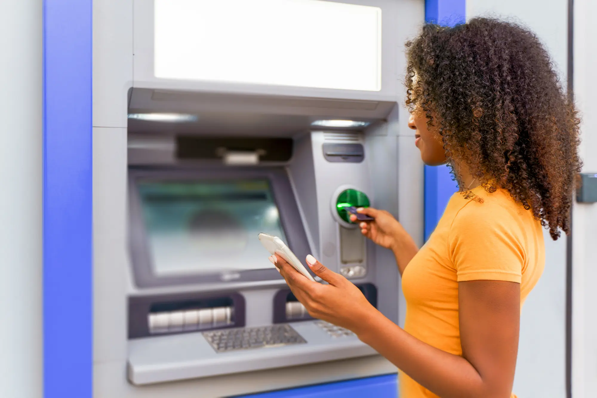 Woman using ATM