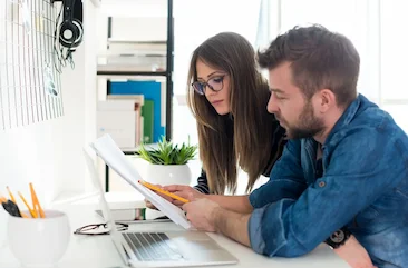 couple previewing finances on computer